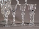 five wine glasses sitting next to each other on a table