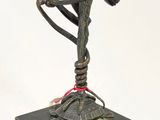 statue of a bird on a turtle on a pedestal with a white background
