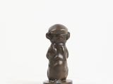 statue of a monkey with a hat on its head