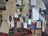 several pieces of paper are hanging from the ceiling of a library