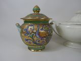 a teapot and a bowl on a white table