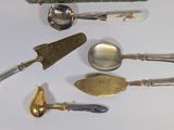 a lot of silver spoons and spoon knives on the table