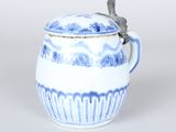 a blue and white cup with a lid and a spoon in it