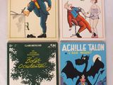 quatre livres pour enfants sont alignés sur une surface blanche
