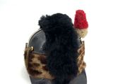 a small stuffed animal sitting on top of a hat