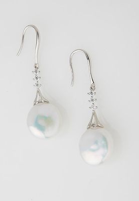a pair of white pearl and diamond earrings on a white background