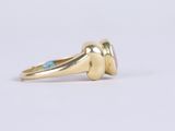 a close up of a gold ring with a blue stone in the middle