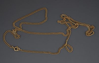a close up of a gold chain with a clasp on a gray background