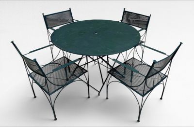 four chairs and a table with a green table top