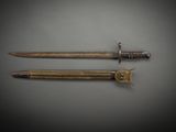a pair of swords, one of which has been used as a weapon, are on display at the museum