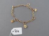 a gold bracelet with charms on it with a price tag