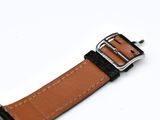 a close up of a watch strap with a buckle on a white surface