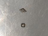 a metal container with a metal lid on a table