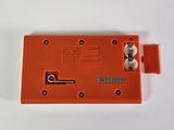 a close up of a small orange device on a white surface