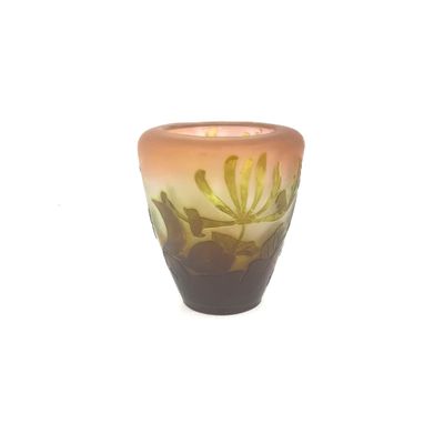 a small glass vase with a floral design on it
