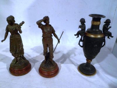 three bronze statues of people standing next to each other