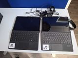 two laptops that are sitting on a table