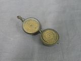 pair of antique brass plated teapots on grey cloth