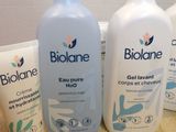 three bottles of body wash on a table next to a bottle of hand sanitizer and a tube of hand sanitizer