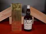 a bottle of wine sitting next to a box on a table