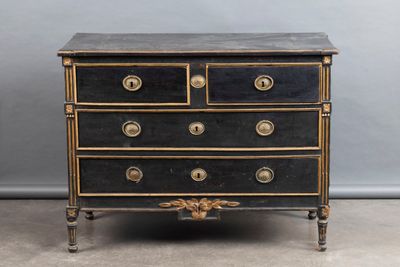 an antique black and gold chest of drawers