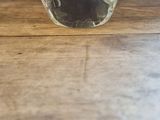 a glass of water sitting on a wooden table