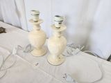 two white vases sitting on a table with wires attached to them