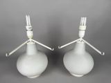 pair of white lamps with metal arms and a white base