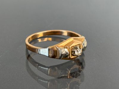 an image of a gold and diamond ring on a black surface