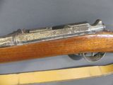 an old rifle with a wooden handle and a wooden handle