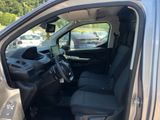 the interior of a car with the door open and the driver ' s seat down