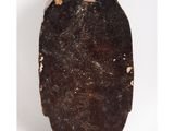 a close up of a black object with a small piece of wood sticking out of it