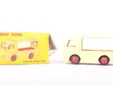 a small yellow toy truck next to a yellow box