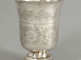 a silver cup that is sitting on top of a table