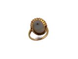 a close up of a gold ring with a pearl on it