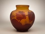 a vase that has a flower on it on a table