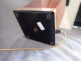 a black and brown box sitting on top of a bed