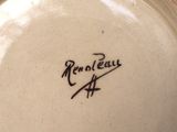 a close up of a plate with a signature on it