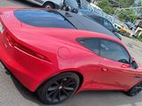 a red sports car parked in a parking lot