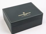 black leather box with a gold logo on the lid