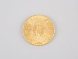 a close up of a gold coin on a white surface