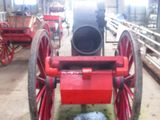 a red wagon that is sitting inside of a building