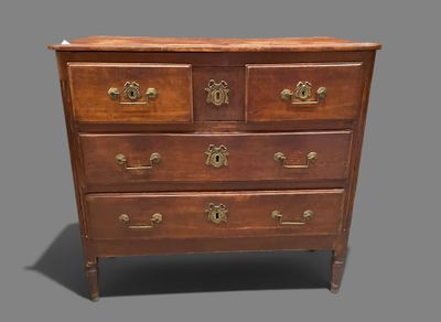 an antique chest of drawers with brass handles on a gray background