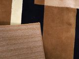 a close up of a rug with different colors and patterns