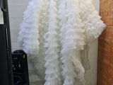a woman that is standing in a room with a dress on