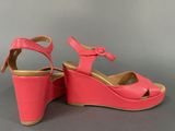 pink wedged sandals with a bow on the toe