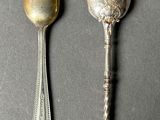 two silver spoons and a silver spoon on a gray surface