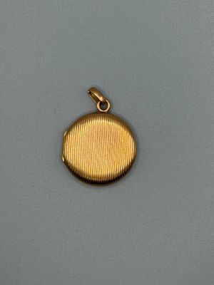 a close up of a gold locke on a gray surface