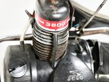 a close up of a motorcycle engine with a red and white sticker on it