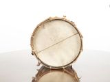 a drum sitting on a table with a reflection on the surface
